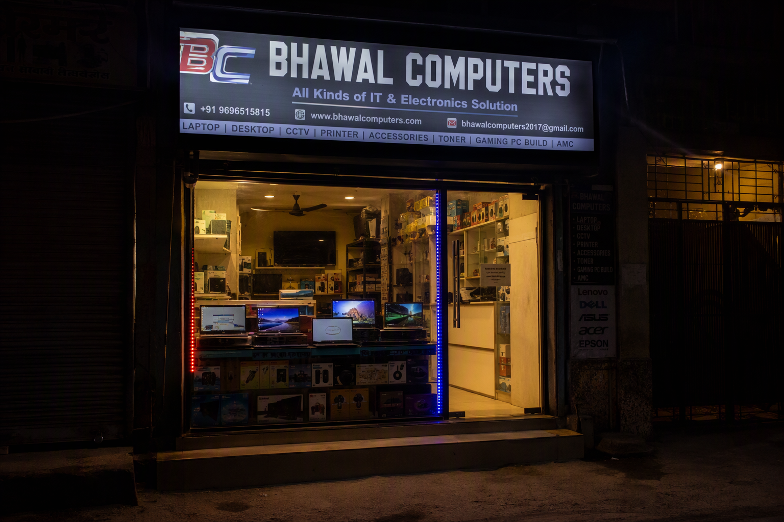 Bhawal Computers storefront at night with the signboard lit